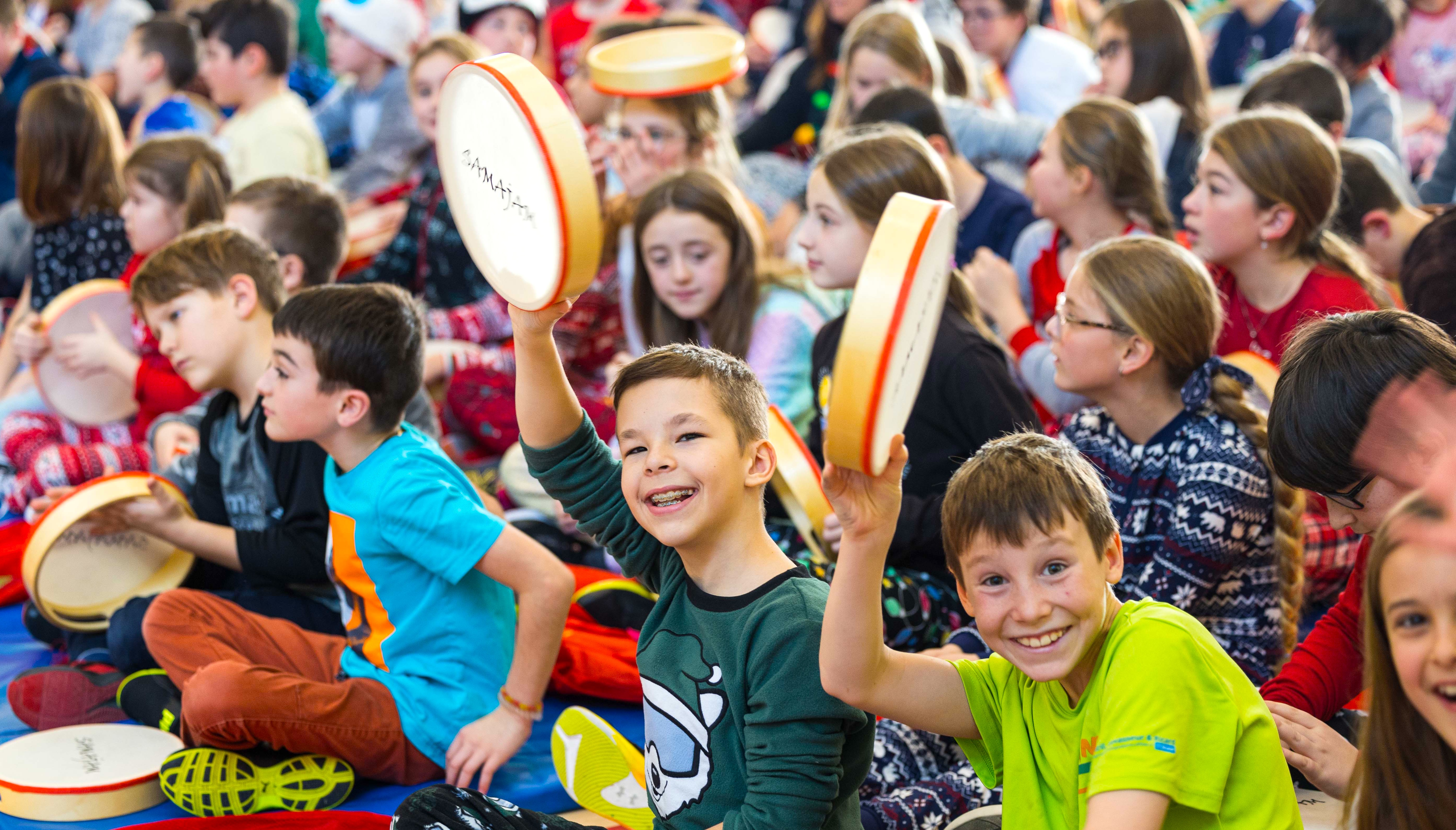 Students take part in the show with tambourines
