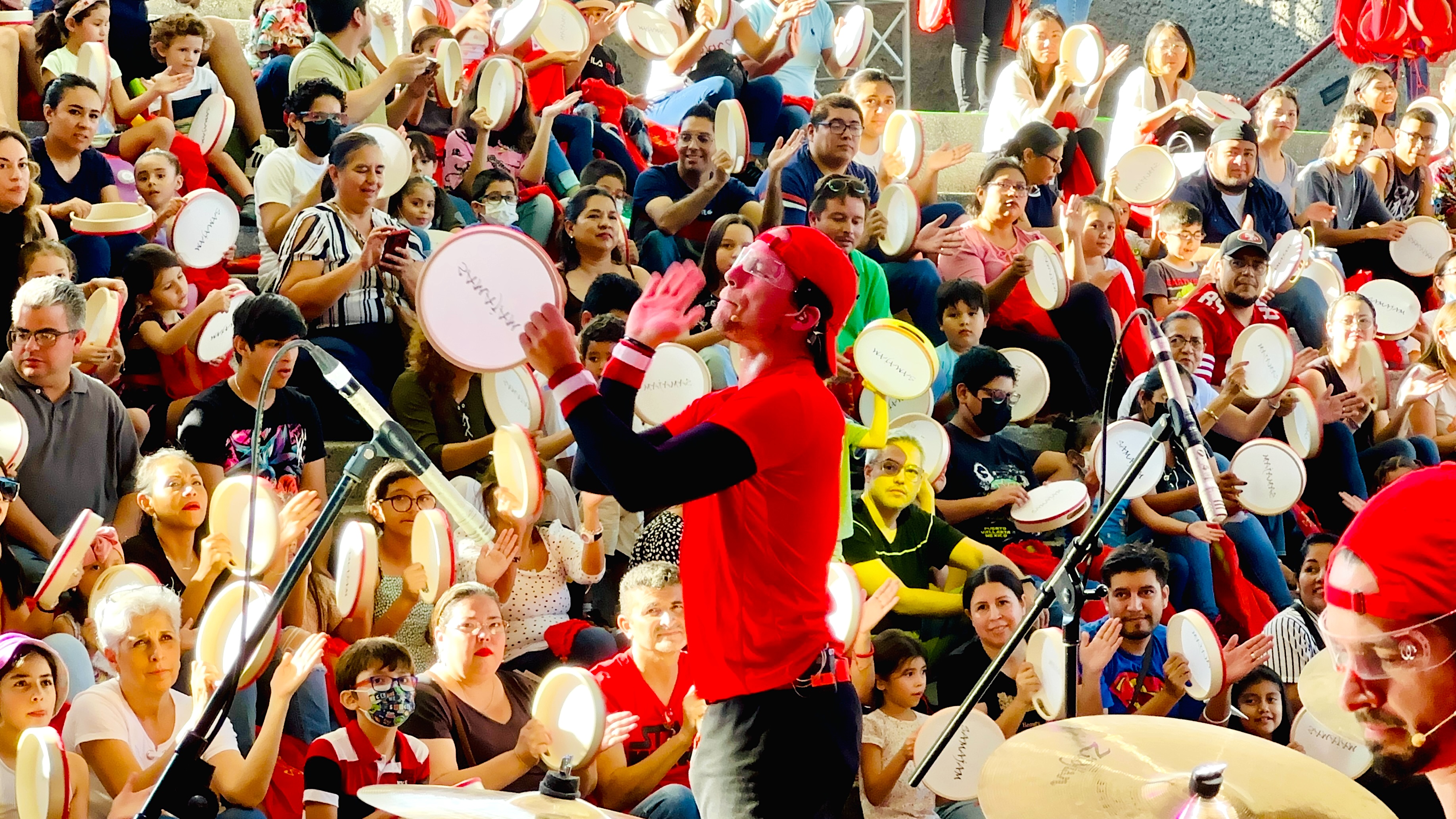 A SAMAJAM artist guides students playing their tambourines