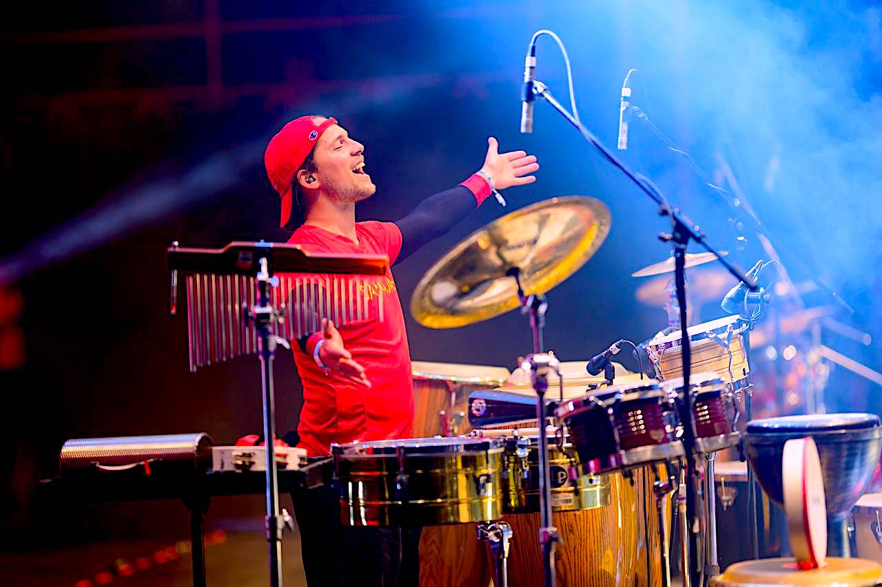 A SAMAJAM artist plays percussion on stage